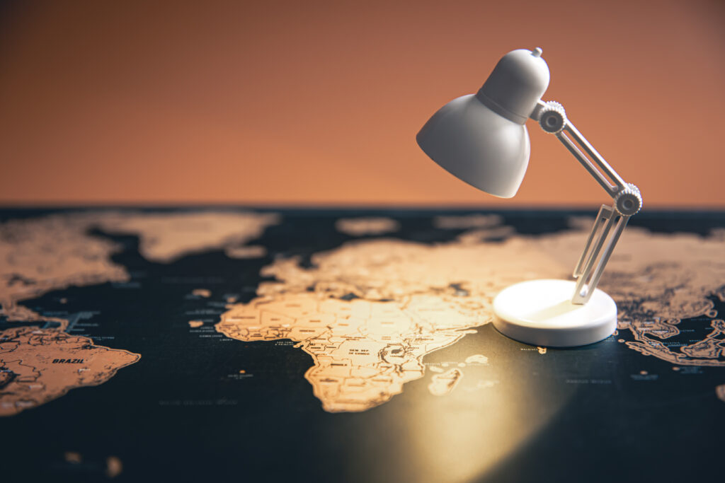 small table lamp on the world map, copy space.